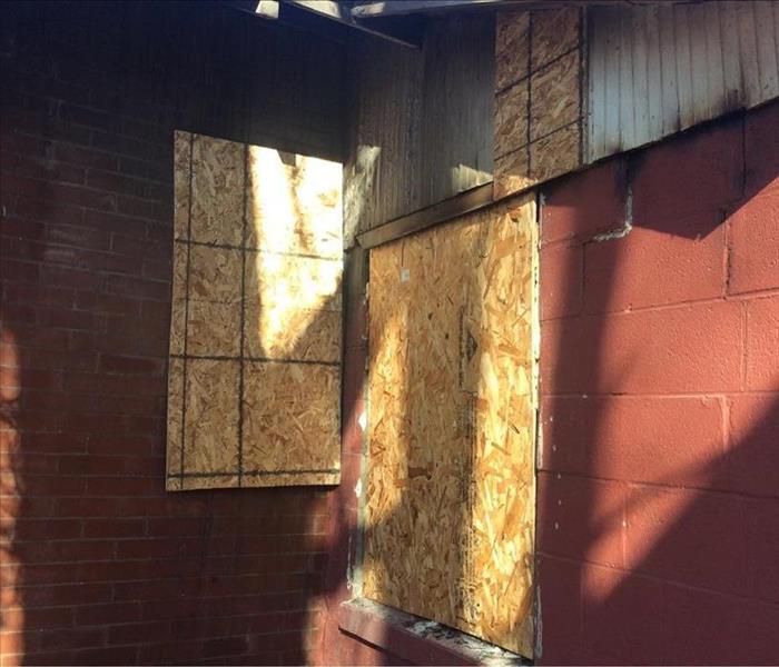 Boarded up windows after House Fire in Ogden