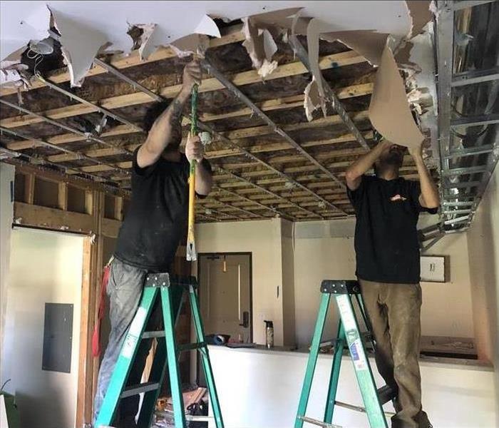 Professionals repairing a Leaky Roof. 